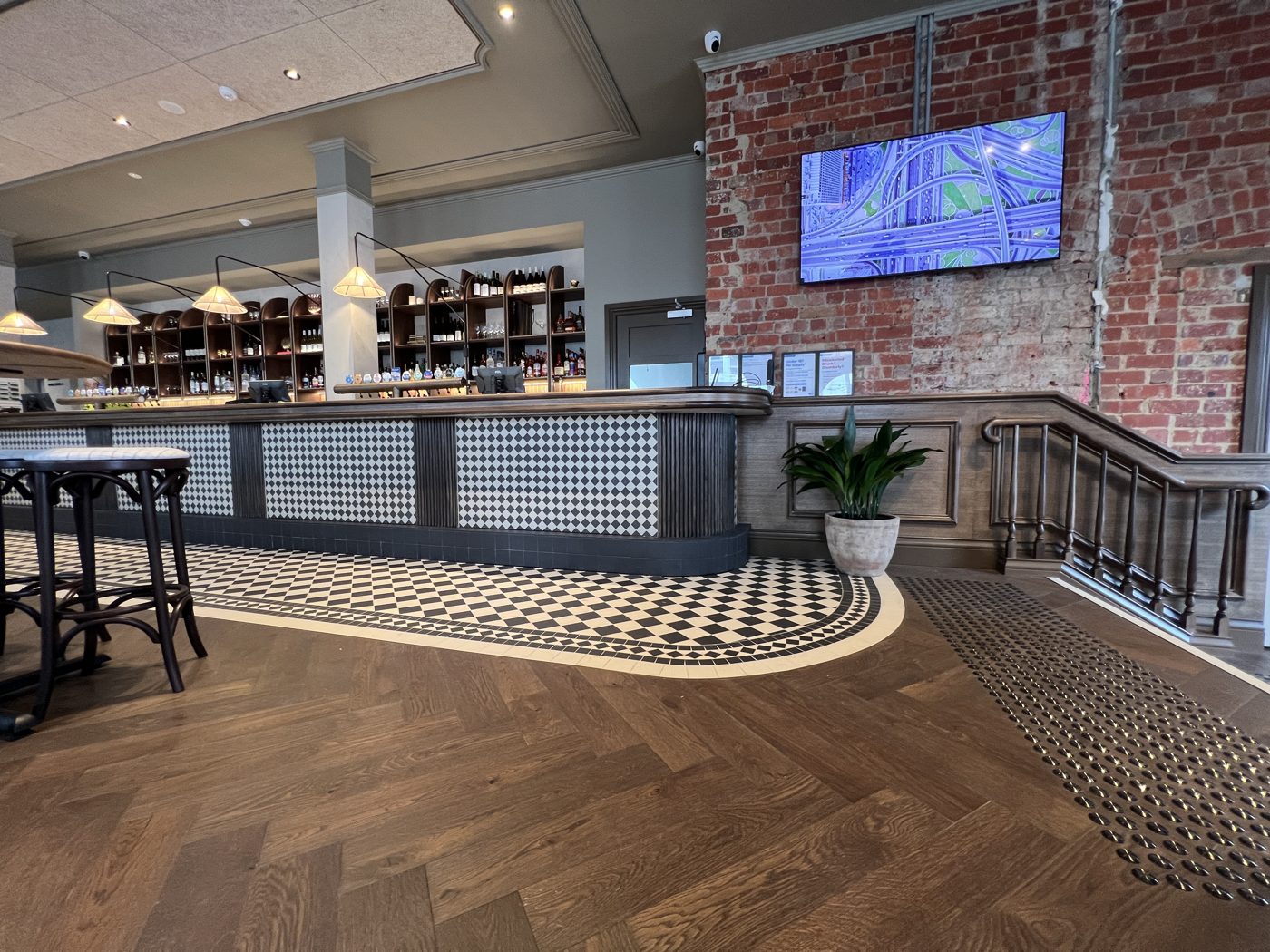 Hospitality bar with mosaic and herringbone floor
