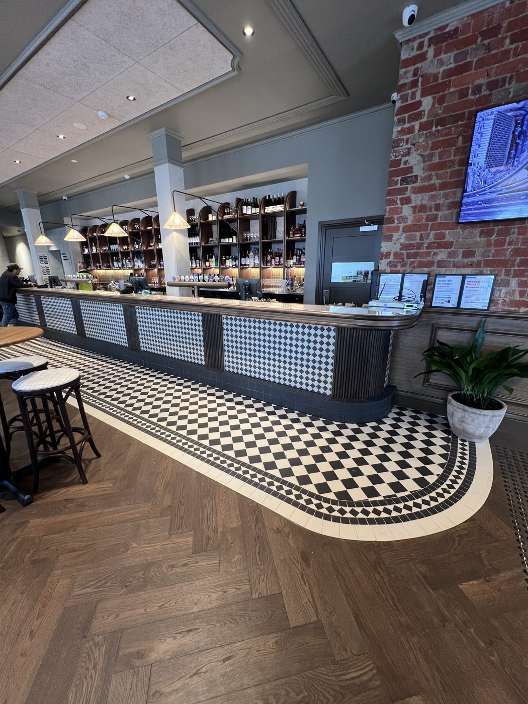 Curved mosaic border around a bar